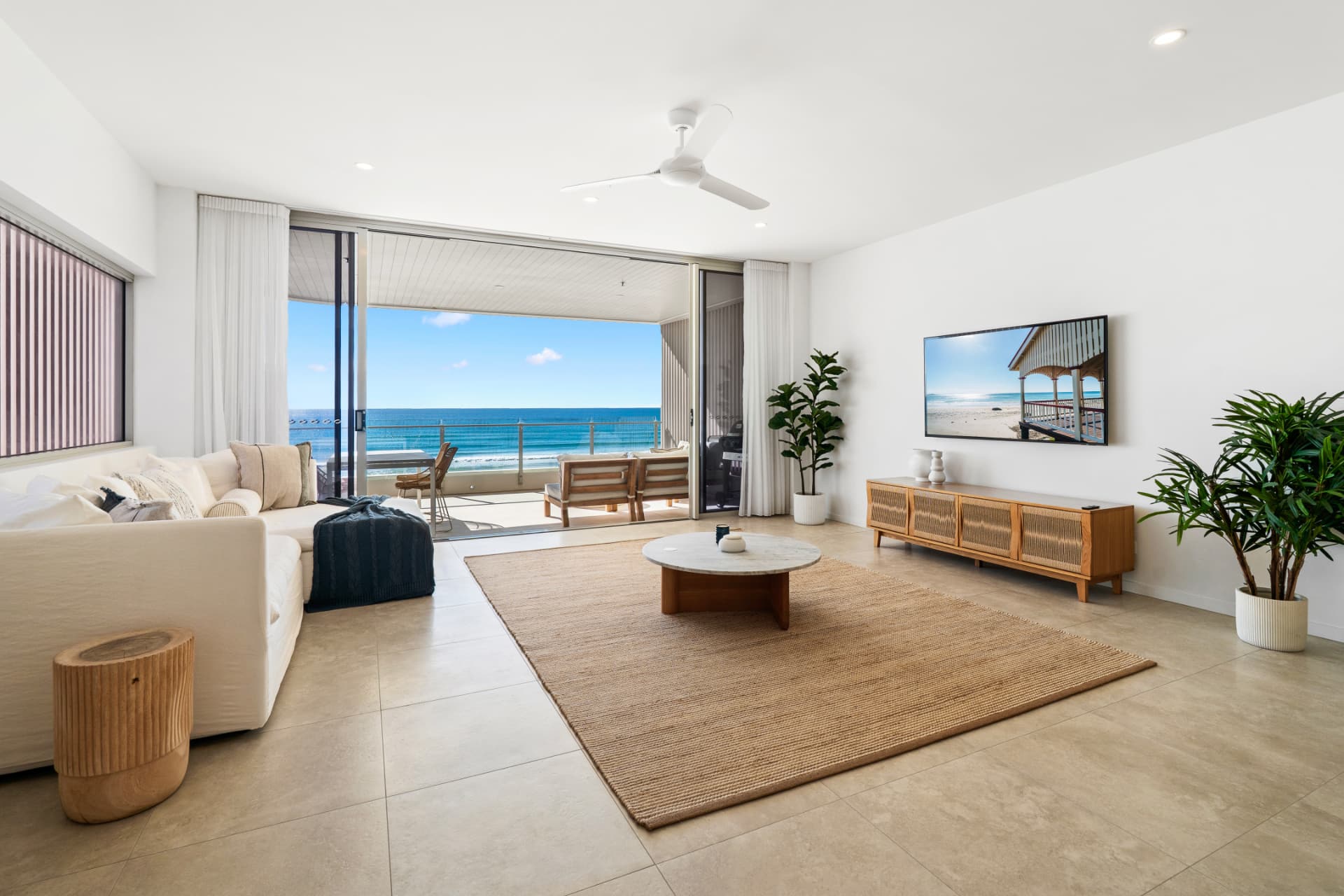 Open-plan living area at Aurum with direct ocean views and balcony access